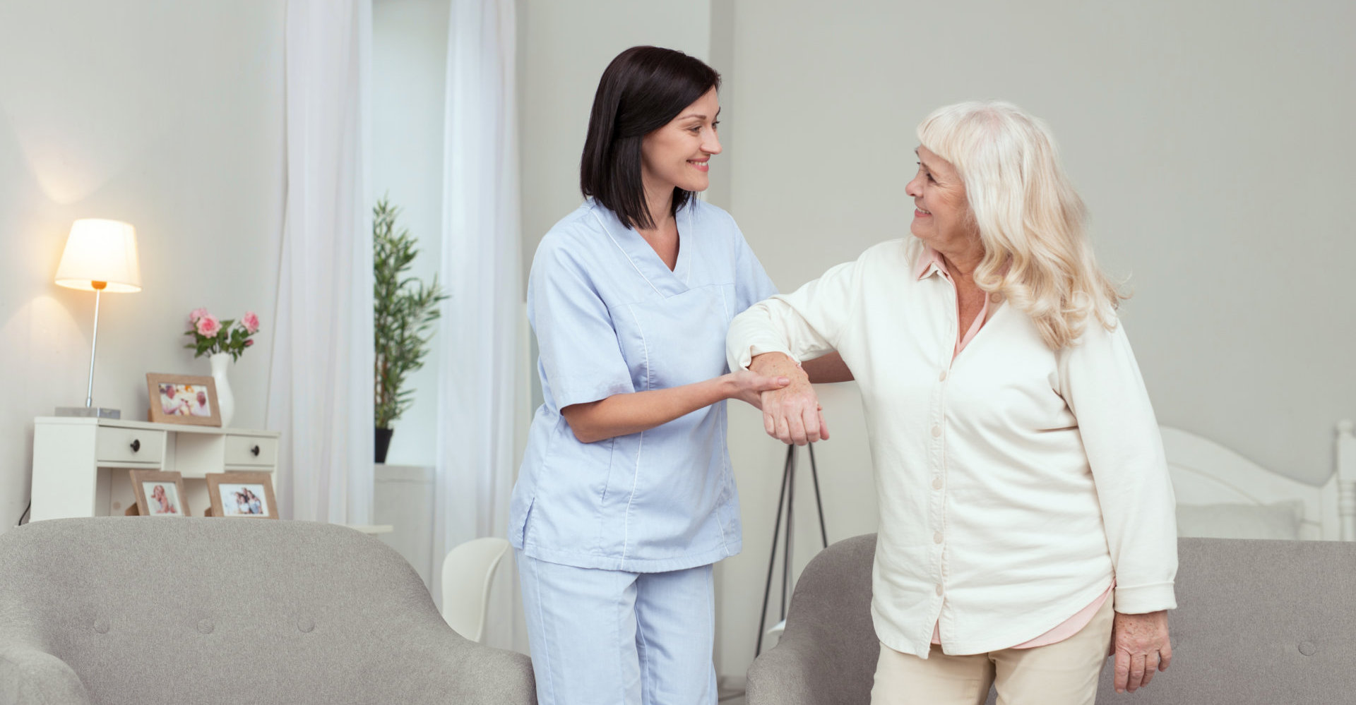 Home Caregiver helping a senior woman