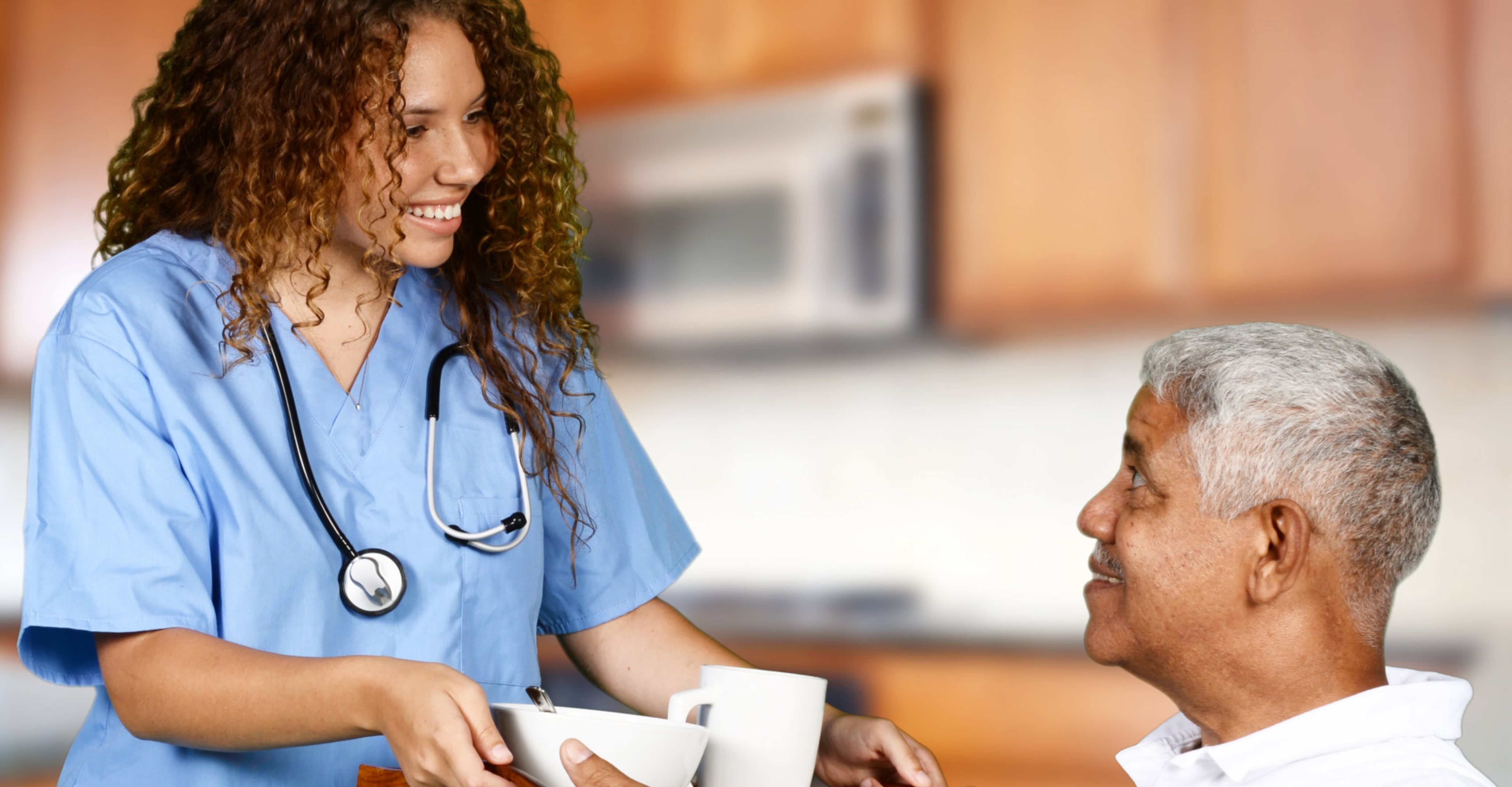 Health care worker helping an elderly man