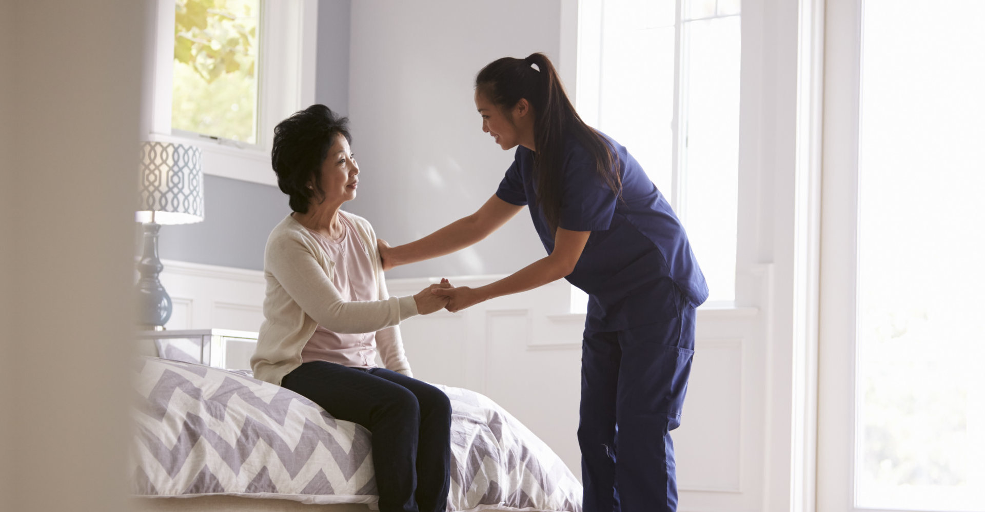 Nurse Making Home Visit To Senior Woman